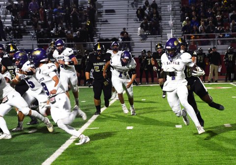Running back Quincy Jones follows his blockers on the way to some positive yardage Friday night against Brackett. He led all rushers with 125 yards. Photo by Mark Lube.
