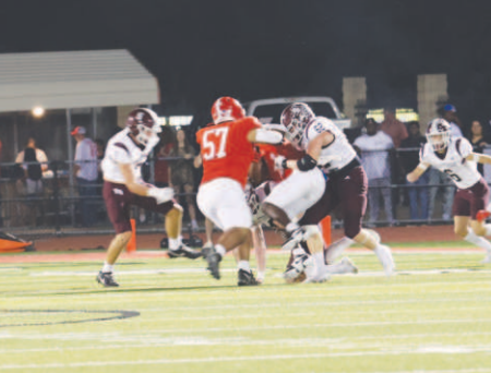 Aiden Drozd (62) wraps up Columbus’ Bryan Salazar. Chuck Grafe/Tribune-Herald