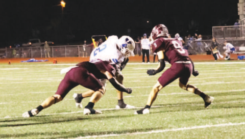 Carter Blaha (21) and Trace Butschek (9) come up to make the tackle on Yoakum’s Tre Cuellar. Chuck Grafe/TribuneHerald