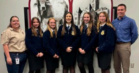 The Hallettsville FFA Ag Issues Team presented an informative debate on the advantages and disadvantages of both conventional and autonomous tractors. From left are Hallettsville Ag-Science instructor Mallory Haas, Ag Issues team members Kaisly Bludau, Alyssa Smith, Aubrey Freytag, Kenley Kalmus, Taylor Yeatts, and HHS principal Mason Briscoe. Photo by Trina Patek