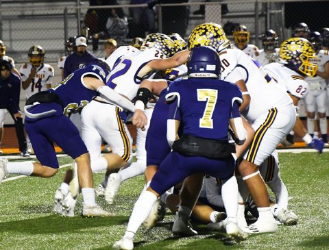 Shiner’s Triston Vesely grabs ahold of Lion running back Caleb Hotbratsch during Shiner’s 43-23 win over Granger in the regional semifinals on Friday. Photo by Mark Lube.