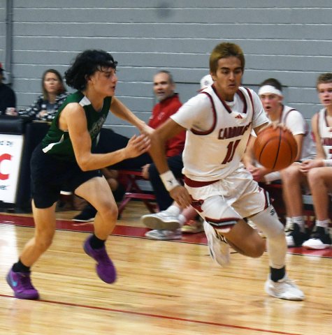 Ezekiel “Zeke” Rodriguez gets past a Gator defender in second-half action. He led the Cardinals with 14 points. Photo by Mark Lube.