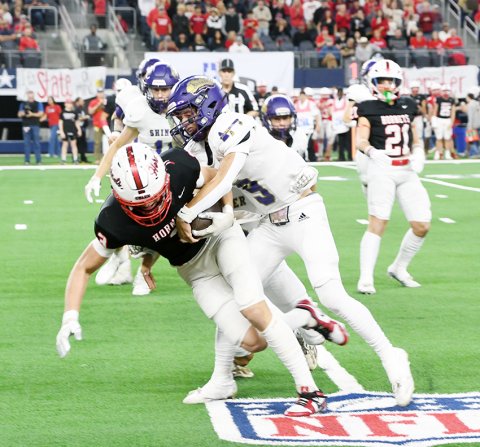 Carson Schuette starts to wrap up a Hornet ball carrier in the first half of the 2ADII state title game at AT&T Stadium.  Photo by Mark Lube.