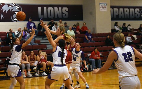Riley Mozisek passes the ball away from a double team against Stockdale on Friday in the tournament. Photo by Mark Lube.