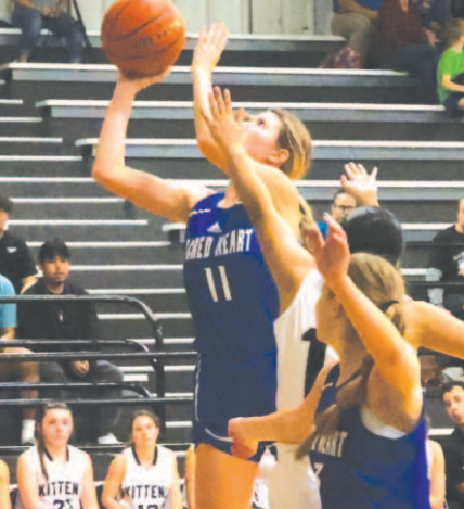 Mallory Mueller scores from underneath in the Moulton game. Chuck Grafe/Tribune-Herald