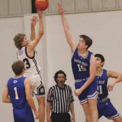 Brody Etzler attempts to block a shot by Moulton’s Landon Chaloupka. Chuck Grafe/ Tribune-Herald