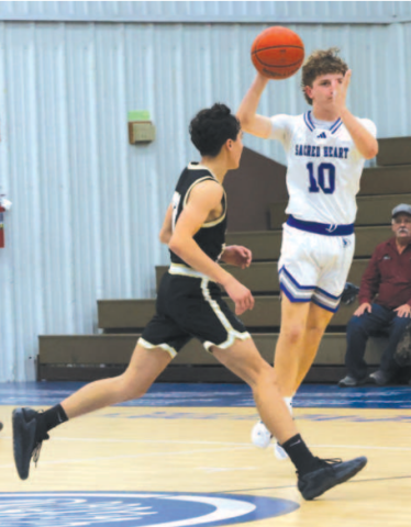 Ty Noska makes a pass vs. RT-C here Dec. 10. Chuck Grafe/Tribune-Herald