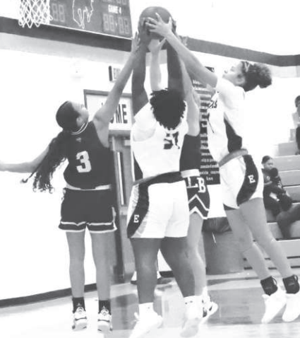 Kasey Harper (3) battles three Cowgirls for a rebound. Chuck Grafe/TribuneHerald