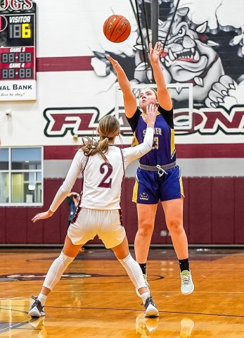 Kailey Boedeker attempts a three-point shot despite Flatonia’s Summer Sodek’s defensive pressure Friday in Flatonia. Photo courtesy of Howard Esse.