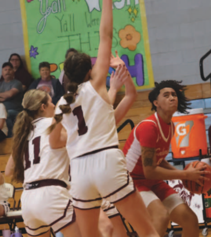 Haven Drozd (11) and Christine Felcman (1) have a road block set up for Columbus’ Anaya Gardner. Chuck Grafe/Tribune-Herald