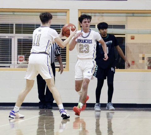 Landen Christensen and Carson Schuette exchange the ball.  Photo courtesy of Louann Heinsohn