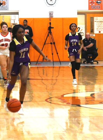Jaliyah Barnett (left) makes her way up court after gaining possession while teammate JaMya Wright trails the play Feb. 4 in Schulenburg. Photo by Mark Lube.