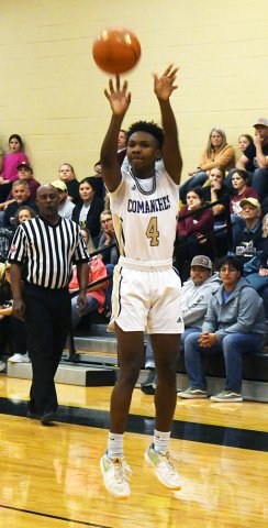 Sophomore Quincy Jones lets a three-point attempt fly during action in the first half against Milano Feb. 17 in Giddings. He contributed two points as the Comanches were bested by the Eagles 62-52. Photo by Mark Lube.
