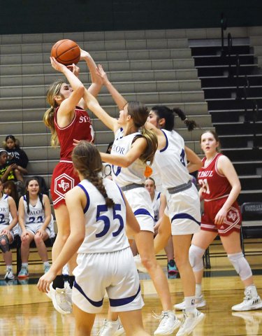 Riley Mozisek tries to shoot the ball past a couple of Lady Knight defenders Friday in the TAPPS 2A regional game in Austin. She led St. Paul with 14 points as Waco Valor Prep prevailed in overtime 48-46. Photo by Mark Lube.