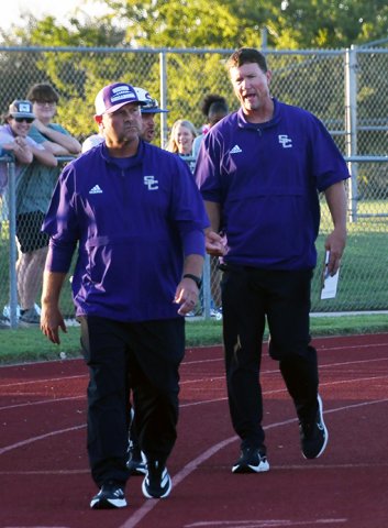 Shiner offensive coordinator, quarterbacks coach and head boys track coach Randy Palmer (right, shown here with head coach Daniel Boedeker prior to the Hallettsville football game in August)  has returned home to Pleasanton to serve as head football coach. Photo by Mark Lube.