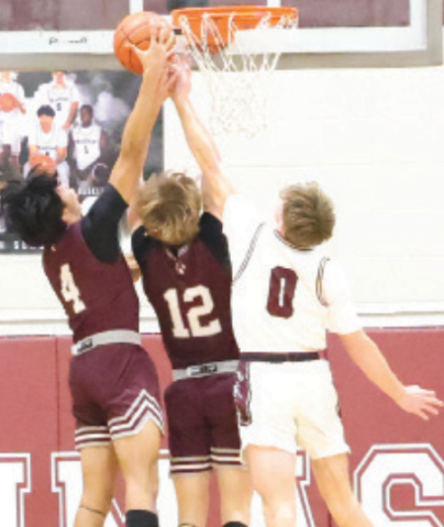 Jack Amsden (0) fights for a rebound vs. Industrial. Chuck Grafe/Tribune-Herald