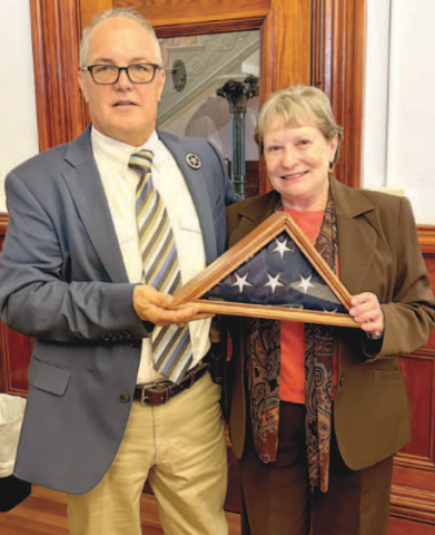 At Monday’s Lavaca County Commissioners’ Court meeting, the court acknowledged Lavaca County Sheriff’s Office employee, Darlene Stacy, who is retiring after 20 years of dedicated service. Stacy was presented the United States flag encased in a wooden frame. The flag had flown over the Lavaca County Courthouse and was folded by Hallettsville Cub Scout Pack 223. Sheriff Steven Greenwell (left) presents Stacy with the flag. Photo by Jimmy Appelt
