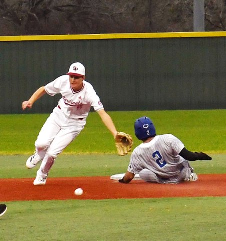 Bulldog Trae Cuellar slides into second before St. Paul’s Cody Malinovsky secures a pass in St. Paul’s March 3 home game against Yoakum. . Photo by Mark Lube.