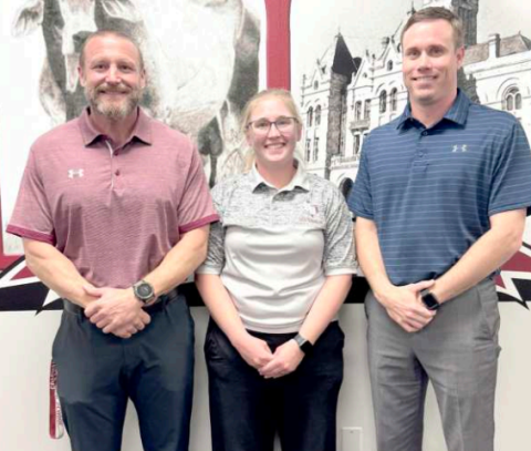 The month of March is National Athletic Training month and Hallettsville ISD athletic trainer, Shannon Flores, was recognized at the Monday, March 10 HISD Board of Trustees meeting. From left are HISD athletic director/head football coach Levi Montgomery, Flores, and HHS principal Mason Briscoe. Photo by Trina Patek