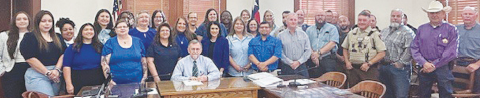Members of the DeWitt County Child Welfare Board, Norma's House and BELONG pose with commissioners as they make a proclamation establishing April as National Child Abuse Prevention Month.