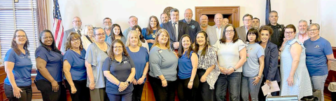 A large group representing various organizations and agencies, who work toward the prevention of child abuse pose for a photo with the Lavaca County Commissioners’ Court at its Tuesday, March 25 meeting. The court approved a proclamation declaring April as Child Abuse Prevention Month. Photo by Jimmy Appelt
