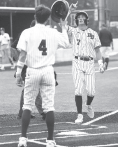 Andrew George is greeted at home plate by Brock Bludau after his two-run homer in the first inning of Game 1 here Thursday. Photo by Chuck Grafe