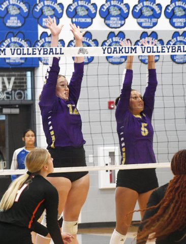 Harlee Sevcik (left) and Kylynn Ramirez attempt a combo block in the Aug. 12 against Gonzales in Yoakum. Photo by Mark Lube.