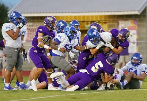 Boe Boehm and several other Comanche players gang tackle a Raider ball carrier Friday night at Comanche Stadium. Shiner limited Rice to under 200 yards of offense and two touchdowns. Photo courtesy of Photos by Lori Raabe.