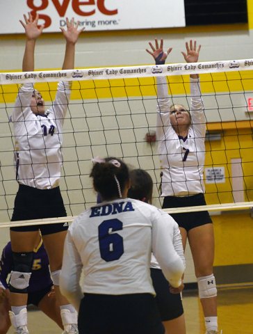 Kayden Smith (left) and Taylor Kocian try to block an Edna attack on Aug. 26 during a Shiner win in five games in the first home match for the Lady Comanches. Photo by Mark Lube.