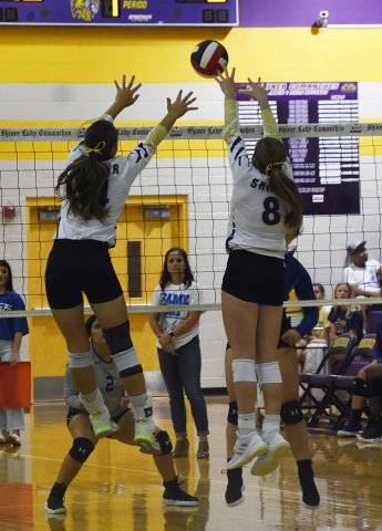 Kayden Smith (left) and Paisly Wallace attempt a block against Rice Consolidated on Friday.  Photo by Mark Lube.