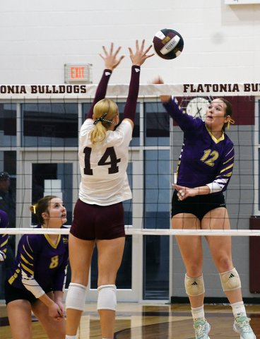 Harlee Sevcik tries to get a hit past the block of Flatonia’s Quinn Arnett with fellow LC Paisly Wallace (left) looking on in Shiner’s five-set loss to the Lady Bulldogs on Sept. 23. Photo by Mark Lube.