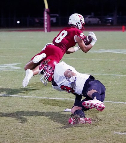Cardinal receiver Jack Ehrig makes a difficult catch against Katy St. John XXIII on Friday. He caught a touchdown pass of 19 yards. Photo courtesy of Photos by Lori Raabe.