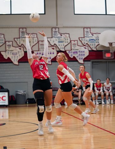 Sloane Kocian makes a set with Emery Kennedy and Reese Chilek also nearby. Kocian had 18 assists in St. Paul’s 3-2 defeat to Yoakum on Aug. 26. Photo courtesy of Photos by Lori Raabe.