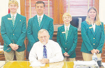 DeWitt County Commissioners make a proclamation declaring the week of Oct. 6 as National 4-H Week. Pictured seated is DeWitt County Judge Daryl Fowler. Pictured in the back row from left to right are DeWitt County 4-H Ambassadors Caleb Keller, Gunnar Frank, Chance Keller, and Emerson Fiessner. Photo by Clayton Kelley.