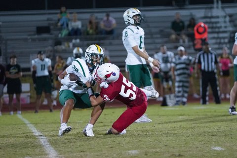 Jack Leonard halts the progress of FBC running back Chase Meyer Friday night at Comanche Stadium. Photo courtesy of Photos by Lori Raabe.