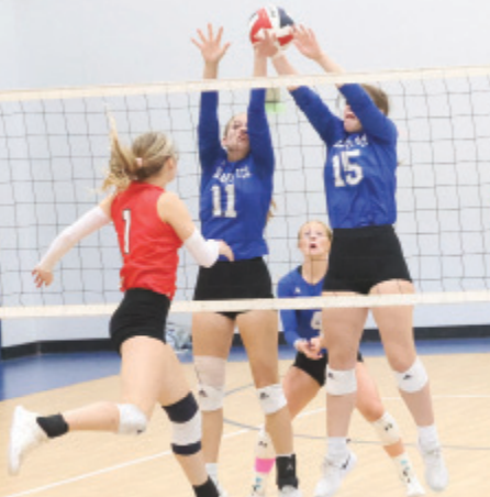 Photo by Chuck Grafe Catherine Lemonds (11) and Jillian Whited (15) just missed a block.