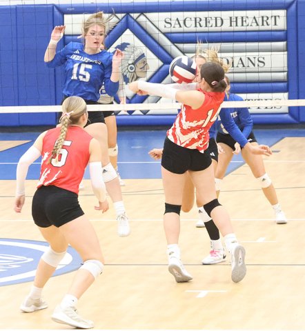 Ashlin DeSarro plays a ball while teammate Skylar Mozisek backs her up in Thursday’s win at Sacred Heart. Photo by Chuck Grafe/Hallettsville Tribune-Herald.