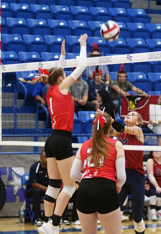 Riley Mozisek attempts to block a Lady Eagle kill attempt with Addy Matias in support. Photo by Mark Lube.