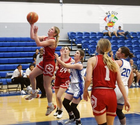 Skylar Mozisek attempts a first-half layup Thursday against Yoakum. She led the Lady Cardinals with 13 points and made one triple. Photo by Mark Lube.