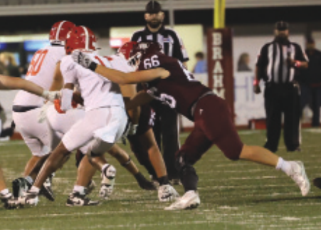 Photo by Chuck Grafe Nathan Henke (66) makes a tackle in the first period.