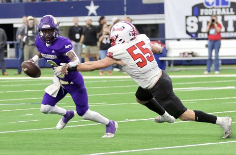 Jarvis Williams tries to run away from Hornet defensive lineman Rhett Walterscheid. The Shiner offense struggled against Muenster’s defense. Photo courtesy of Louann Heinsohn.