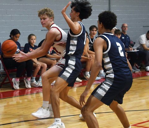 Tyler Pendley tries to pass the ball while dealing with a Goliad double-team. Photo by Mark Lube.