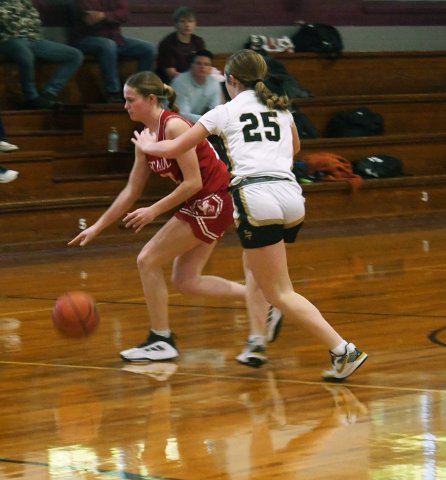McKinley Jacobs attempts to dribble towards the basket while a Giddings player attempts to slow down or stop her in Thursday’s Flatonia Tournament game won by Giddings 52-49. Photo by Mark Lube. 