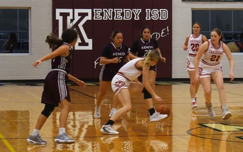 Riley Mozisek (center) scrambles to grab a loose ball in the first half on Friday against Kenedy in the Kenedy Tournament with Addy Matias (21) and Kristin Cerny (20) also in the area. Shiner won the game 61-25. Photo by Mark Lube.
