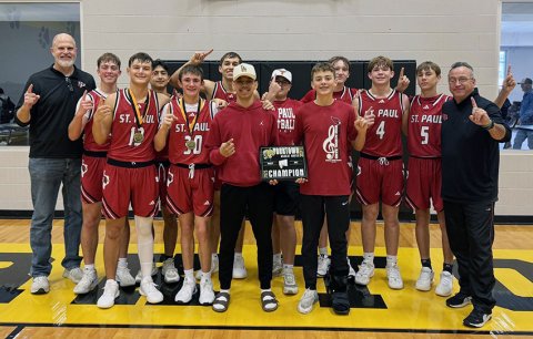 The St. Paul boys basketball team pose with their Yorktown Tournament Champions trophy. Photo courtesy of St. Paul Booster Club.