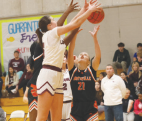 Photo by Chuck Grafe Christine Felcman fights for a rebound in the Smithville game.