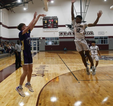 Flatonia’s Jaylon Anderson (right) tries to defend a three-point shot by Landen Christensen. Christensen made one three and finished with 12 points in Shiner’s 64-46 win. 