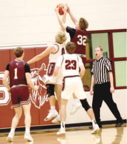Photo by Chuck Grafe Nathan Henke (0) and Industrial’s Ryan Riddle vie for a rebound