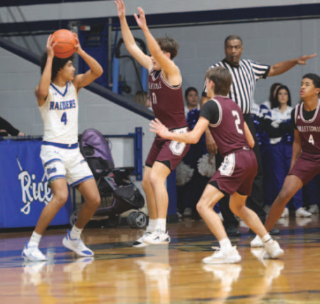 Photo by Chuck Grafe Cainen DeLeon, center and Will Halata (2) harass Rice’s. JT Amos.