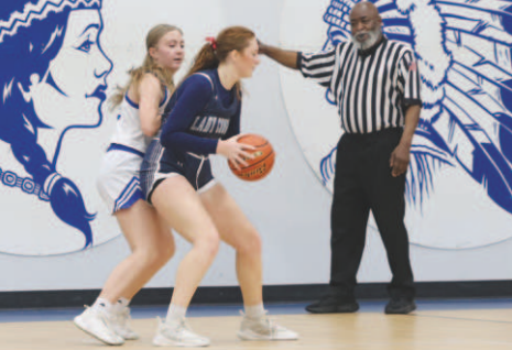 Photo by Chuck Grafe Kennedy Zappe guards Faith Academy’s Callie Humpherey
